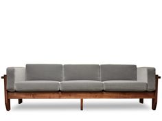 a gray couch sitting on top of a wooden frame