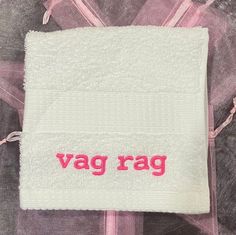 a pink and white towel with the word vag rag written in red on it