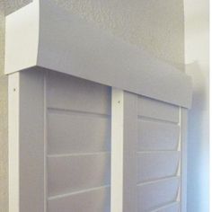 a white book shelf with two doors on each side