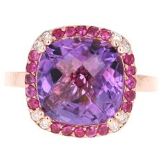 Amethyst, Pink Sapphire, and Diamond Cocktail Ring Playful yet Powerful! Its like having a piece of glittery candy on your finger! This ring has a Checkers Cushion Cut Amethyst that weighs 5.94 Carats and is embellished with 20 Pink Sapphires that weigh 0.54 Carats as well as 8 Round Cut Diamonds that weigh 0.15 Carats. The total carat weight of the ring is 6.63 Carats.  The Amethyst has a gorgeous purple hue and measures at 14 mm x 14 mm.  The ring is crafted in `14 Karat Rose Gold and weighs a Rose Gold Cocktail, Yellow Gold Cocktail Ring, Diamond Cocktail Ring, Pink Sapphire Ring, Gold Cocktail Ring, Gold Cocktail, Diamond Cocktail Rings, Modern Ring, Sapphire Diamond