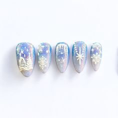 Step into a frosty fairytale with our Winter Wonderland press-on nails, a breathtaking combination of icy blues, glistening glitter, and intricate white details. Each nail captures the essence of a magical winter scene, with delicate snowflakes, twinkling stars, and a charming snowy village design. The shimmering base provides a radiant glow, reminiscent of snow-covered landscapes under a starry sky. These nails are perfect for anyone looking to add a dash of winter magic to their style. With their intricate detailing and sparkling finish, "Winter Wonderland" is sure to elevate your look for any holiday party, winter getaway, or cozy night in. 🎀 With every order we send an Essentials Tool Kit for free! What's included in the kit: 1 nail file  1 wooden stick  1 sheet with 24 sticky tabs 2 Snowy Winter Nails, Winter Ice Nails, Winter Scene Nails, Snow Flake Nails Design, Simple Christmas Nails Blue, Icy Nails Winter, Blue Snow Nails, Nagel Design Winter, White Winter Nail Designs