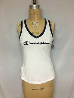 Champion womens  Heritage V-Neck Ringer Tank W4914 White NWT $25 Power through your toughest workouts in this logo tank by Champion.  PRODUCT FEATURES V-neck Contrast trim Logo graphic Washed to provide added softness Jersey construction FABRIC & CARE 60% Cotton 40% Polyester Machine wash  S  - Bust 32    Length 22  L  - Bust 36   Length 24  XL  - Bust 38   Length 25  Retail $25           Please Note - Actual Color may vary due to flash or personal monitor settings.  Please contact if you have a Contrast Trim, Logo Graphic, Active Wear Tops, Fabric Care, Active Wear, Women Accessories, V Neck, Tank Tops, Human