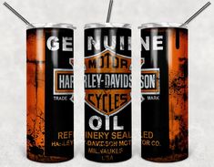 three cans of harley davidson oil are shown in this graphic art work, one is orange and the other is black