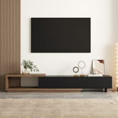 a living room with a large flat screen tv mounted on the wall above it's entertainment center