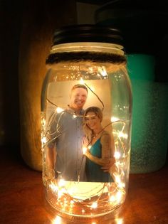 a mason jar filled with lights and a couple