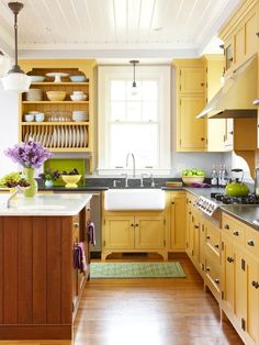 the kitchen is clean and ready to be used for cooking or baking, with yellow cabinets