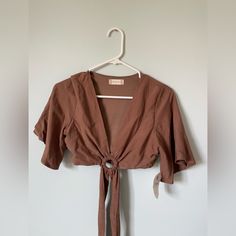 Super Cute Top For Going Out! It Ties In The Front/Around The Waist. Unworn And With Tags. The Brand Is Altard State. Fits Xs-M (It Fit Me And I Have 32dd Chest) Brown Short Sleeve Crop Top For Spring, Brown V-neck Crop Top For Spring, Brown V-neck Summer Top, Spring Brown Short Sleeve Crop Top, Brown Spring Beach Crop Top, Summer Brown V-neck Top, Brown Crop Top For Spring Vacation, Brown Crop Top For Vacation In Spring, Fitted Brown Crop Top For Spring