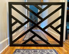 a hallway with an area rug on the floor and a mirror in the wall above it