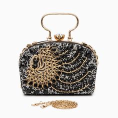 Decked out in magnificent peacock-patterned rhinestones, this clutch exudes unparalleled uniqueness and flair. Beyond its stunning appearance, it blends functionality seamlessly with style, featuring a chic chain strap and ample interior space. Its splendid design encapsulates sophistication, guaranteeing that every graceful movement catches the eye and turns heads. Now available in gold, and black. Chic Evening Bag With Bling For Night Out, Glamorous Clutch With Rhinestones For Night Out, Luxury Rhinestone Evening Bag For Party, Luxury Chain Shoulder Bag For Party, Luxury Party Shoulder Bag With Chain, Glamorous Rhinestone Clutch For Night Out, Glamorous Rhinestone Clutch For Formal Events, Luxury Rhinestone Party Evening Bag, Glamorous Rhinestone Formal Clutch