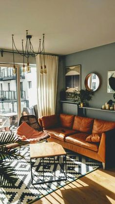 a living room filled with furniture and a large window