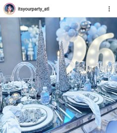 the table is set with silver and white decorations