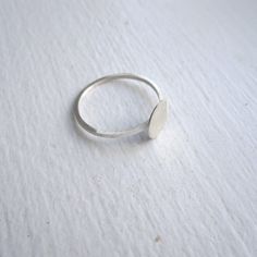 The Tiny Silver flat disk Ring is perfect for everyday wear. The design of this ring is very elegant and simple. The ring has a smooth, matte finish and the width of the band is 1 mm. The tiny flat disk has a diameter of 7mm. This ring is a perfect for stacking. Package in a brown kraft box. Ear Jacket Earring, Silver Flats, Geometric Circle, Silver Circle, Ring Minimalist, Ring Dainty, 14k Gold Ring, Dainty Ring, 925 Jewelry