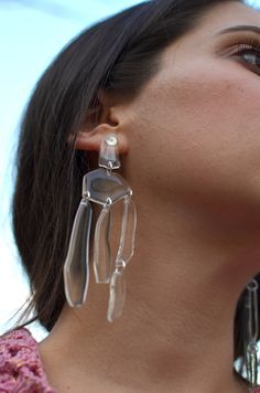 a close up of a person wearing earrings