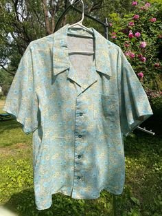 "Soft Blue and Pale Yellow Flowered One of a Kind Hawaiian style summer shirt. Celebrate yourself or someone you love with this so, so soft blue floral summer shirt. The shirt has a comfortable roomy cut, perfect for warm summer days and nights. The attention to details in this shirt make it an extraordinary find for the perfect person. This shirt is made from an lightweight cotton blend vintage fabric and has blue buttons up the front (with an extra inside for repairs).  Size: Men's Large Measurements: chest around: 52\" waist around: 52\" across shoulders back: 22\" Back length neck to hem: 30\" Fabric has been prewashed, so it will not shrink Machine wash, tumble dry, Iron inside out on poly setting" Cocoon Jackets, Sally Brown, Celebrate Yourself, Perfect Person, Hawaiian Style, Plaid Shorts, Red Wool, Style Summer, Style Shirt