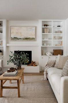 a living room filled with furniture and a fire place under a painting on the wall