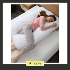 a woman laying on top of a white pillow