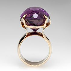 This well designed vintage cocktail ring features one (1) oval cut amethyst set with four prongs. The stone flashes a pinkish-orange when viewed from the side. The ring measures 26.3mm at the top, rises 14.9mm above the finger, tapering to 9.4mm wide and 1.6mm thick at the base of the shank.  It is currently a size 5.75. Luxury Solitaire Amethyst Ring, Oval Amethyst Ring With Bezel Setting For Formal Occasions, Luxury Oval Amethyst Ring With Prong Setting, Luxury Oval Amethyst Ring For Formal Occasions, Timeless Polished Amethyst Ring For Formal Occasions, Modern Amethyst Ring With Center Stone For Formal Occasions, Luxury Oval Solitaire Amethyst Ring, Unique Oval Amethyst Ring For Formal Occasions, Formal Polished Amethyst Ring