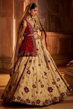 Gold tissue lehenga with attached can-can all-over floral embroidery. Comes with embroidered padded choli, worked belt and contrasting red tulle dupatta.
Component: 4
Pattern: Embroidered
Type Of Work: Floral Pattern
Neckline: Plunged V-Neck
Sleeve Type: Half
Fabric: Tissue, Tulle
Color: Gold
Other Details: 
Bead hem blouse and dupatta
Cutwork hem
Note:
Only selling the red dupatta
Contact customer service to get the 2nd dupatta
Occasion: Bride, Wedding - Aza Fashions Diwali Lehenga With Tilla And Kundan, Diwali Kundan Lehenga With Tilla Detailing, Kundan Lehenga With Tilla For Navratri, Bollywood Style Lehenga With Tilla For Eid, Navratri Kundan Lehenga With Tilla Details, Kundan Tilla Lehenga For Navratri, Wedding Pre-draped Saree With Tilla, Festive Semi-stitched Lehenga With Tilla Details, Unstitched Wedding Lehenga With Tilla Embroidery