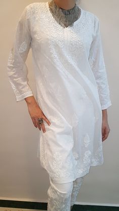 Feel the Soft Cotton Tunic in White splendor embroidered by hand and made for you. Length stands at 36 inches with side slits for comfort. Available in sizes : S - bust 36 M - bust 38 L - bust 40 XL - bust 42 0X - bust 44 Elegant Embroidered Fitted Tunic, Fitted Cotton Tunic With Chikankari Embroidery, Fitted Cotton Tunic With Floral Embroidery, Traditional Fitted Tunic With Chikankari Embroidery, Fitted Summer Kurta With Embroidered Border, Spring Fitted Tunic With Chikankari Embroidery, Traditional Fitted Tunic With Floral Embroidery, Fitted Long Kurta With Floral Embroidery, Fitted Straight Tunic With Resham Embroidery