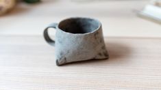 a coffee cup sitting on top of a wooden table