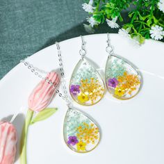 Product Details: Pendant Size: 30mm The set includes a pair of earrings and a necklace Material:Silver,Resin,Real Flower 🎁 Gift Box Wrapping: Unique rings are suitable for women. Wife, Girlfriend, Mother, Grandmother, Daughter, Women Friends and yourself. 🍃 Free shipping: The package needs about 3-10 days to get all over the world. Thank you so much for visiting and hope you enjoy shopping with us 💕 Please feel free to contact me with any questions :) Mother's Day Flower Shaped Jewelry With Matching Earrings, Yellow Round Jewelry For Mother's Day, Mother's Day Nickel-free Flower Earrings, Teardrop Pressed Flowers Jewelry Gift, Sterling Silver Drop Earrings Jewelry Sets As Gifts, Flower Shaped Hypoallergenic Jewelry Gift, Round Jewelry Sets For Mother's Day Gift, Mother's Day Gift Pendant Earrings, Hypoallergenic Flower Shaped Jewelry For Gifts