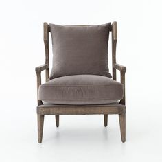 a gray chair with a pillow on it's back and arm rests against a white background