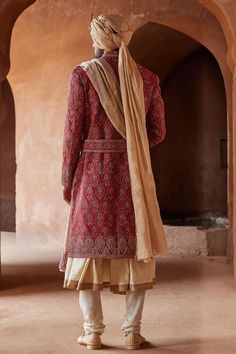 Red full sleeve sherwani, highlighted with all over peacock feather motif embroidery. Paired with a beige monga tussar kalidar kurta and churidar.
Components: 3
Pattern: Embroidery
Type Of Work: Peacock, Thread, Zardozi
Neckline: Stand Collar
Sleeve Type: Full Sleeves
Fabric: Matka Silk and Monga Tussar
Color: Red
Other Details: 
Model height: 6ft, wearing size M
Note: The belt, shawl, footwear and safa worn  by the model is not for sale
Occasion: Destination Wedding,Groom - Aza Fashions Kalidar Kurta, Beige Kurta, Embroidered Sherwani, Blouse Yoke, Motif Embroidery, Indian Groom, Indian Wedding Outfits, Pattern Embroidery, Kurta With Pants