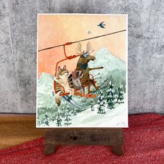 a card with a painting of a dog on a sled being pulled by a reindeer