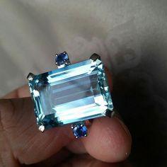 Specification:- Stone Details :-  *Diamond Material : Cubic Zirconia (CZ) *Center Diamond Shape : Emerald Cut *Total Diamond Weight : 5.33 CT (Approx.) *Center Diamond Dimension : 11*9 MM  *Center Diamond Weight : 5.21 CT *Side Diamond Dimension : 2.40 MM  *Side Diamond Weight : 0.12 CT *Diamond Color : Blue, Aquablue *Clarity : VVS *Making Process: Handmade by our Experienced Staff. *Stamp: Our All Rings Stamped According to metal Purity (925 SIL/10K/14K/18K). Procedure information Please selec Elegant Blue Crystal Emerald-cut Ring, Elegant Blue Emerald-cut Crystal Ring, Blue Emerald Cut Crystal Ring In Fine Jewelry Style, Light Blue Diamond Wedding Jewelry, Elegant Blue Crystal Ring With Gemstone Accents, Light Blue Topaz Ring With Brilliant Cut For Wedding, Light Blue Topaz Wedding Ring With Brilliant Cut, Wedding Light Blue Topaz Ring With Brilliant Cut, Light Blue Jewelry With Diamond Accents For Wedding