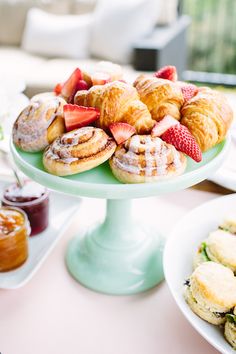 there are many pastries on the table and in the plates next to each other