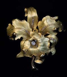 For Sale on 1stDibs - Circa 1910 This very large antique matte and polished green 18K gold brooch is superbly modeled as a stylized orchid embellished with numerous old rose Luxury Flower Brooches For Wedding, Luxury Brooches With Rose Cut Diamonds, Luxury Wedding Brooches With Single Cut Diamonds, Luxury Wedding Brooch With Single Cut Diamonds, Luxury Single Cut Diamond Brooch For Wedding, Luxury Single Cut Diamond Wedding Brooches, Luxury Gold Brooches With Rose Cut Diamonds, Elegant Gold Brooches With Rose Cut Diamonds, Elegant Gold Diamond Brooch