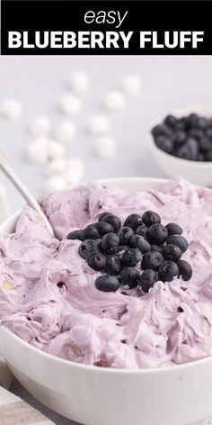 a bowl filled with blueberries and whipped cream