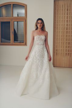 a woman in a white wedding dress posing for the camera