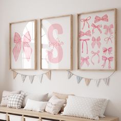 three framed pictures hang on the wall above a wooden bench with pillows and pillow cases