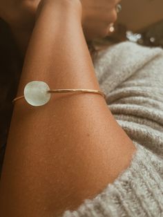 This Seaglass Banle is crafted from beautiful gold filled metal and features a round light blue sea glass bead. With its size of 6,7, or 8” this bangle is perfect for all wrist sizes. It's an eye-catching piece sure to make a statement. Bangle Ring, Round Light, Blue Sea Glass, Glass Bead, Blue Sea, Earring Necklace, Sea Glass, Body Jewelry, Necklaces Bracelets