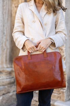 🌟Experience Italian Artistry with Our Handcrafted Flat Leather Briefcase🌟 Embrace elegance with our Handcrafted Leather Briefcase, meticulously made in Tuscany. This tan leather bag is exceptionally flat, making it sleek and easy to carry, perfect for the modern professional who values practicality and style. Crafted from premium full-grain leather, it combines timeless charm with a slim, compact design that's ideal for professional and casual settings alike. 🌟 Slim and Functional Design Our Brown Everyday Rectangular Briefcase, Brown Rectangular Everyday Briefcase, Luxury Brown Briefcase For Gift, Brown Everyday Briefcase Rectangular Case, Classic Briefcase For Daily Use, Cognac Rectangular Case Bag For Everyday Use, Everyday Leather-lined Rectangular Case Bag, Classic Pouch Briefcase For Everyday Use, Elegant Formal Handmade Satchel