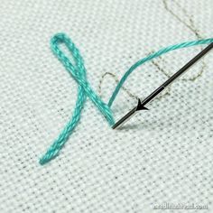 the thread is being used to make an embroidery project