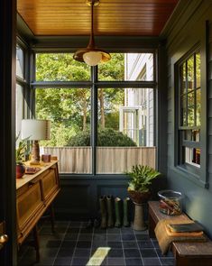 the sun shines in through an open window into a room with blue walls and tile flooring