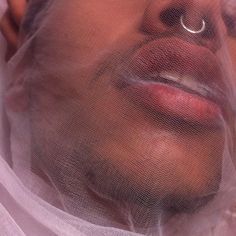 a man wearing a veil and nose ring