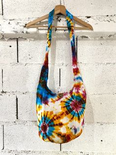 This gorgeous tie-dye hippie-style bag is great for everyday use, features an inside pocket and is 100% cotton. Zip and button closure Stylish, unique design Handmade and hand dyed Base is lined Inside pocket Patterns will vary as each bag is unique but the colours will be similar Multicoloured Free UK delivery Width - 38 CM (approximately) Zip to base - 26 CM (approximately) Top of strap to bottom - 85 CM  (approximately) Inside pocket size width - 17 cms and height - 15.5 cms (approximately)   Thank you for supporting my small business :) Summer Festival Cotton Hobo Bag, Casual Cotton Hobo Bag For Festival, Bohemian Multicolor Cotton Hobo Bag, Casual Tie Dye Cotton Bag, Multicolor Hippie Hobo Bag, Multicolor Cotton Hobo Bag For Daily Use, Multicolor Cotton Shoulder Bag For Beach, Festival Cotton Shoulder Bag With Adjustable Strap, Hippie Summer Hobo Bag For Daily Use