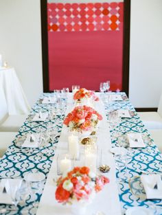 a long table with candles and flowers on it