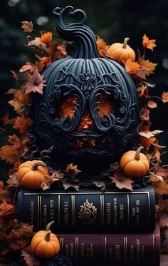 two books are stacked on top of each other with pumpkins and leaves around them