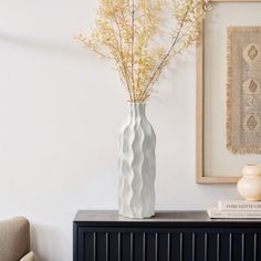 there is a vase with flowers in it next to a radiator