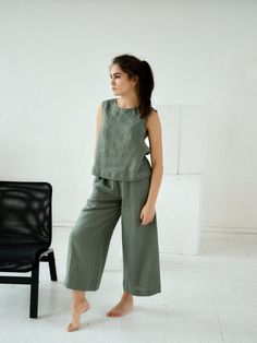 "Moss green culottes linen pants for woman. Midi loose flared pants with pockets. Choose size: XS Waist 66 - 68 cm. / (26\" - 26 3/4\") Hips 90 - 92 cm. / (35 1/2\" - 36 1/4\") S Waist 70 - 72 cm. / (27 3/4\" - 28 1/4\") Hips 94 - 96 cm. / (37\" - 37 3/4\") M Waist 74 - 76cm. / (29 1/4\" - 30\") Hips 98 - 100 cm. / (38 1/2\" - 39 1/4\") L Waist 78 - 80 cm. / (30 3/4\" - 31 1/2\") Hips 102 - 104 cm. / (40 1/4\" - 41\") XL Waist 82 - 84 cm. / (32 1/4\" - 33\") Hips 106 - 108 cm. / (41 3/4\" - 42 1 Green Relaxed Fit Wide Leg Pants, Green Relaxed Fit Wide Leg Pants For Summer, Green Wide Leg Pants With Relaxed Fit For Summer, Green Wide Leg Pants With Pockets For Summer, Spring Khaki Linen Pants, Spring Green Wide-leg Culottes, Green Wide Leg Culottes For Spring, Casual Green Wide-leg Culottes, Green Cotton Wide Leg Pants For Summer