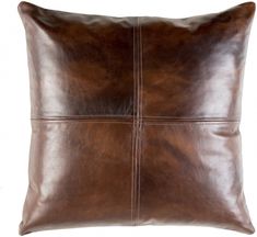 a brown leather pillow on a white background