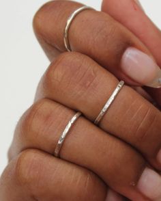 The Silver Hammered Stacking Ring Set features three soldered rings that are handmade to order. Each set includes three stackable rings that have a subtle shiny sparkle. These rings can be worn all together on one finger, and also look great spread out on multiple fingers. Available in midi and regular sizes. Please provide up to three sizes at checkout. If no size is provided, I'll make the rings in a general midi ring size (3, 4, 4.5) *Size comparison: a normal ring size 6 would usually fit a Hand Full Of Rings Silver, Adjustable Double Band Stackable Rings For Anniversary, Everyday Adjustable Hammered Stackable Rings, Minimalist Stackable Metal Jewelry, Minimalist Metal Stackable Jewelry, Silver Double Band Stackable Dainty Rings, Minimalist Hammered Silver Stackable Rings, Silver Dainty Double Band Stackable Rings, Gift Double Band Stackable Bands