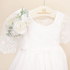 Handmade in the USA An elegant gown that is sure to make your little one the star of their special day! The Ella Christening Gown is made with a detailed flower and vine embroidered netting lace in light ivory with a mini scalloped edge for a classic and vintage heirloom style. A sweet flutter sleeve is the perfect accent to the styling of this gown! A two-tiered lace skirt creates added fullness and flounce, and is lined in a super soft and light weight cotton, while the romper is made in a sof Wedding Gown With Floral Applique And Fitted Bodice, Cream Gown With Lace Bodice And Tulle, Cream Gown With Lace Bodice And Tulle Material, Lace Dress With Fitted Bodice For First Communion, Lace Gown With Floral Applique And Fitted Bodice, Lace First Communion Dress With Fitted Bodice, Cream Wedding Dress With Floral Applique, First Communion Dress With Lace Bodice In Organza, Fitted Organza First Communion Dress With Lace Bodice