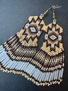 Handmade beaded fringe earrings are a fusion of tradition, artistry, and contemporary Native American design. Each piece of jewelry is unique. Additional photos in listings are to show you our large range of styles and colors.  *CUSTOM ORDERS ACCEPTED. PLEASE ALLOW 2-4 WEEK TURNAROUND FOR CUSTOM COLORS AND EARRINGS.* Browse our shop: https://nativeamericancurio.etsy.com  About Native American beadwork/fringe earrings also known as "shoulder dusters": Native American beadwork is an art form creat Traditional Fringe Beaded Earrings With Round Beads, Traditional Beaded Earrings With Fringe And Round Beads, Traditional Fringed Beaded Earrings, Traditional Beaded Earrings With Beaded Fringe, Artisan Beaded Earrings With Fringe, Native American Inspired Fashion, Mode Coachella, Native American Beadwork Earrings, Bead Fringe Earrings