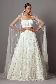 Ivory lehenga featuring embroidered 3-D bellflower motifs in jaal pattern, highlighted by pearls and crystals. Comes with matching embroidered strapless blouse and embellished trail dupatta. - Aza Fashions Tube Blouse, Indo Western Lehenga, Sangeet Outfit, White Lehenga, Reception Outfit, Lehenga Blouse Designs, Indian Dresses Traditional, Lehenga Blouse, Ivory Bridal