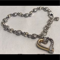 Heart Shaped Charm With Rhinestones Makes This Silver And Gold Tone Bracelet Rare. Has Extender For Bigger Wrists. Perfect Accessory For Any Occasion. New Without Tags. Elegant Silver Charm Bracelet With Heart Beads, Elegant Silver Open Heart Bracelet, Elegant Silver Heart Charm Bracelet, Elegant Silver Heart Bracelet, Silver Heart Bracelets With Silver Beads, Silver Heart Bracelet With Diamond Accents, Silver Heart Bracelets With Diamond Accents, Silver Heart Bracelet With Diamond Accents For Anniversary, Heart-shaped Silver Bracelets With Diamond Accents